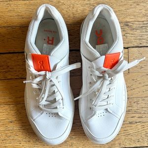 On Running White and Orange Athletic Shoes
